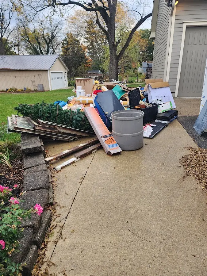 Dumpster being loaded with debris for Roofing Dumpster Rental in Schertz